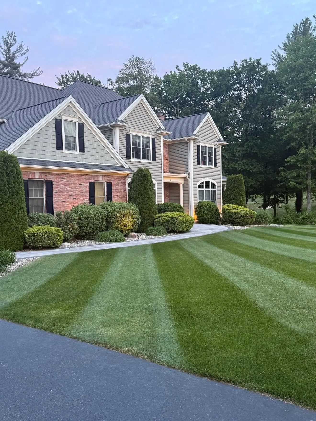 Manicured striped lawn surrounding a Southwick-area home